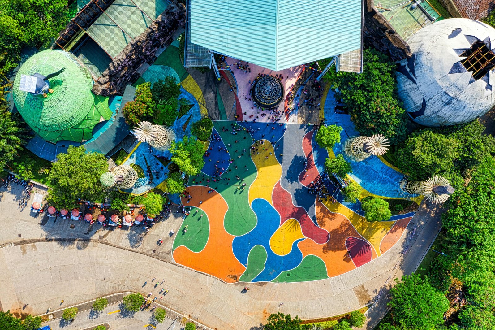 A vibrant aerial shot of a colorful park in West Java, showcasing unique architectural elements.